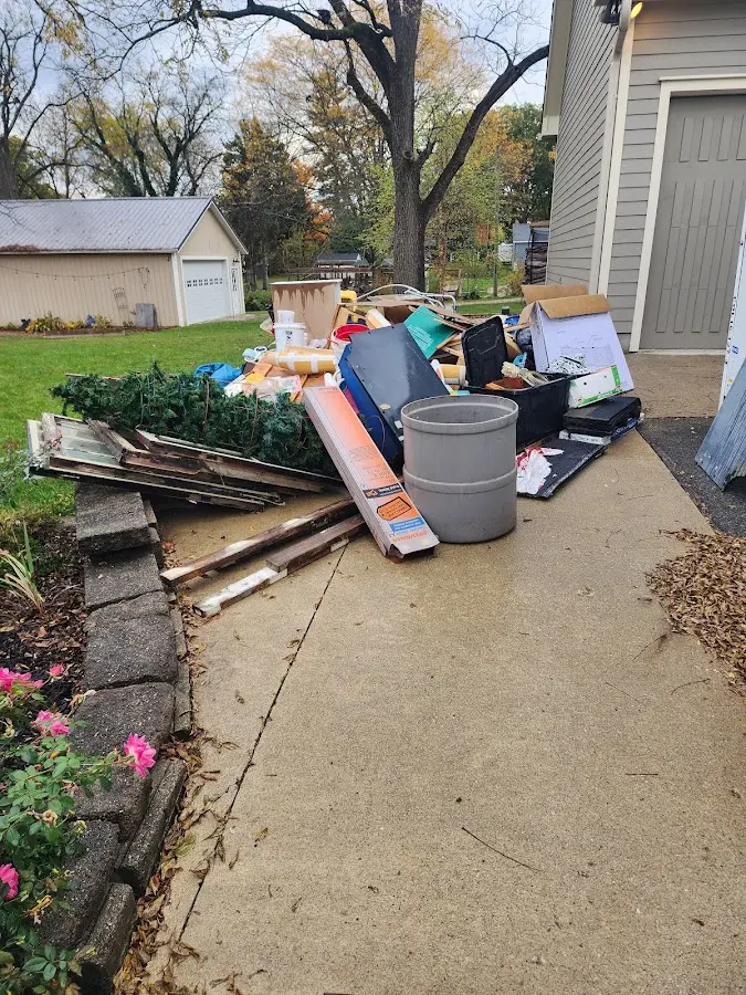 Dumpster being loaded with debris for 12 Yard Dumpster Rental in Fairland